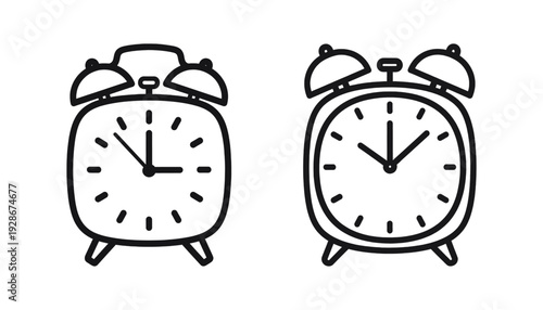 Two simple black and white analog alarm clocks side by side