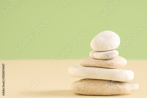 Stack of pebbles on color b...