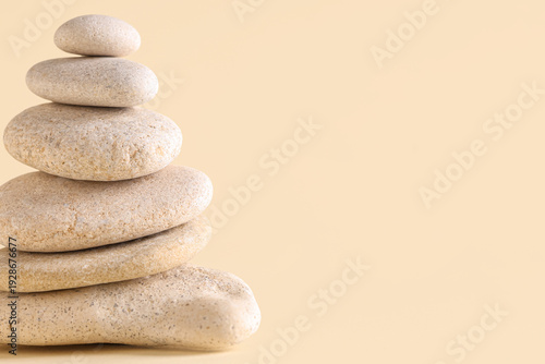 Stack of pebbles on yellow ...