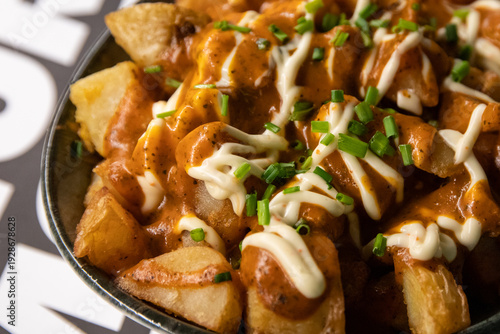 Fotografie Patatas bravas in bowl with copy space and soft background