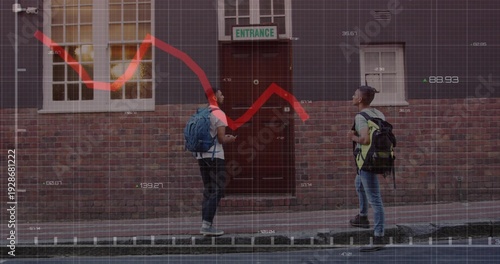 Chatting pair with blue and blackgreen bags checking phone on sidewalk by redbrick wall, chart