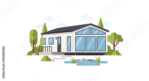 A modern white modular home with large glass windows is situated in a green landscape with trees and a small blue pond in the front.