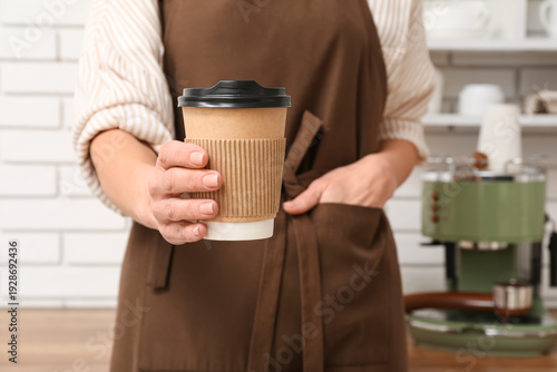 Young female barista holdin...