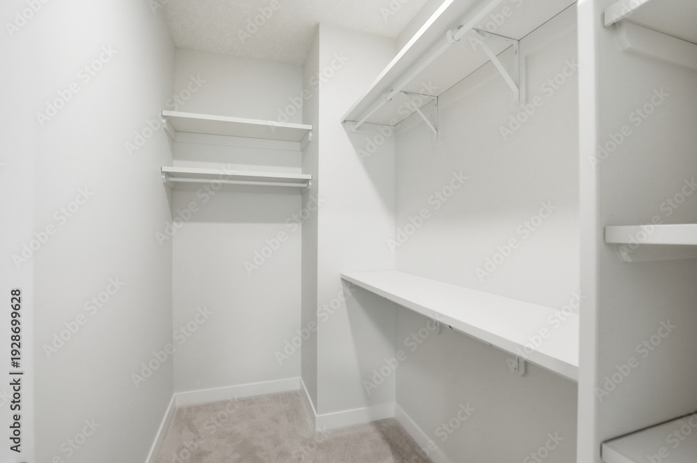 Fototapeta premium Small white closet with shelves and a white desk