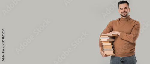Handsome man with stack of ...
