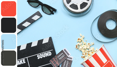 Frame made of movie clapper with popcorn, cinema tickets and film reels on bl...