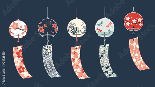 Row of five colorful Japanese glass wind chimes decorated with cherry blossoms, dragonflies, and waves on a dark background.