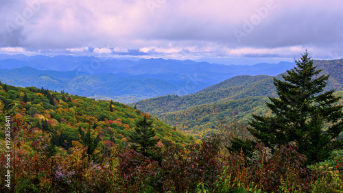 фотографія A panoramic view of rolling mountains covered in autumn foliage under a cloudy sky