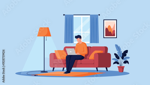 Young man works remotely on his laptop while sitting comfortably on a sofa in a modern and cozy living room environment.