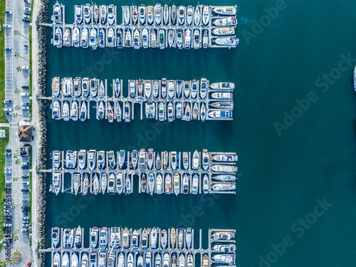 Top down aerial view of Long Beach marina with aligned yacht docks and luxury boats, coastal real estate and investment concept in Southern California