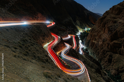 Long exposure of cars on a very windy road at night producing light trails.
