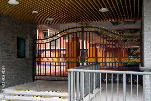Close-up of a large iron gate of a primary and secondary school