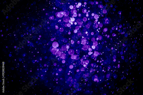 Blurred photo with purple violet and blue dots visible glittering, shining brightly look and feel luxurious