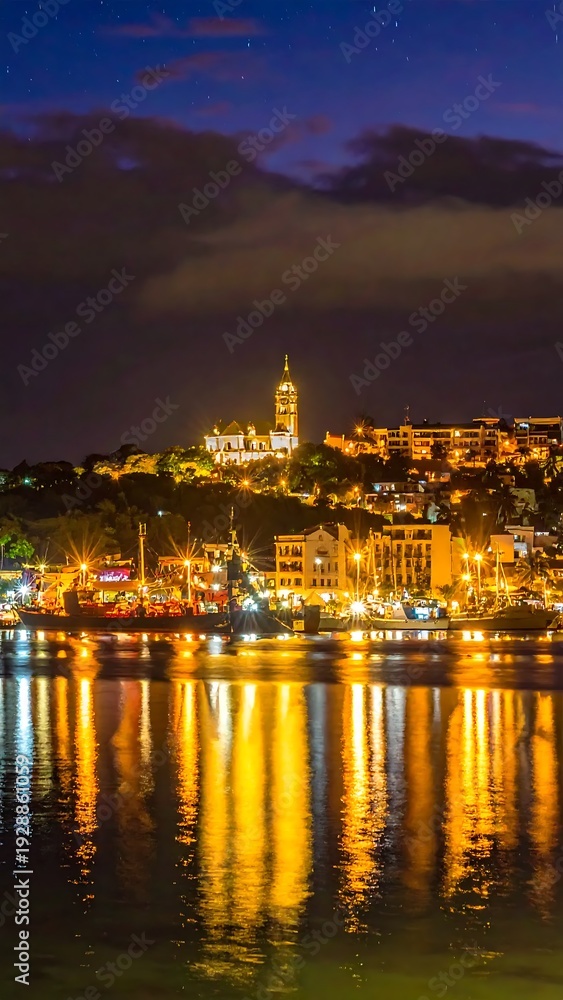 Fototapeta premium A serene nighttime cityscape reflected on calm waters (1)
