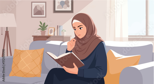 A Young Muslim Woman Wearing a Hijab Reads a Book While Sitting on a Comfortable Sofa in a Cozy Living Room