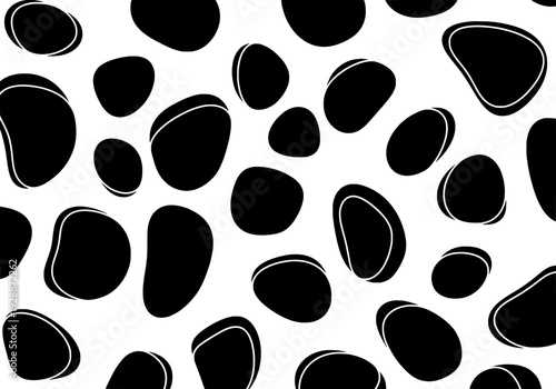 Various black stones scattered randomly on a plain white background viewed from directly above