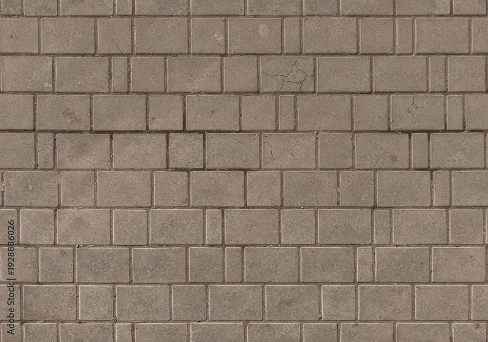 Obraz premium Rectangular stone wall with weathered texture in outdoor setting