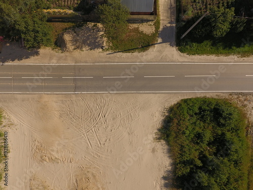 Wallpaper Mural Empty sandy lot next to rural road bordered by trees from aerial view Torontodigital.ca