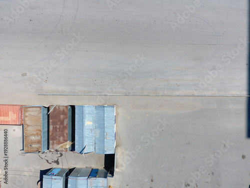 Wallpaper Mural Shipping containers arranged beside empty paved area in industrial yard Torontodigital.ca