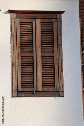 Wallpaper Mural Closed wooden shutter on white exterior wall in daylight outdoor Torontodigital.ca