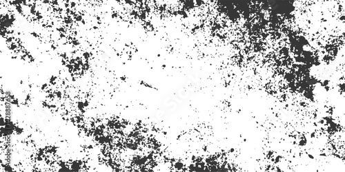 This abstract black and white grunge background features a dirty ink splatter texture with a spray paint design and dark artistic water drops in a vector illustration pattern