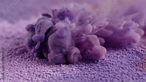 Purple cloud-like form with textured surface emerges from grainy ground. Soft color palette, artistic