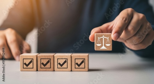 Hand places a scale of justice block aligning with checklist cubes, symbolizing AI ethics, compliance, and responsible development
