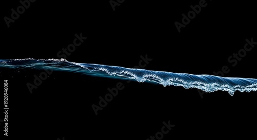 Wave crest breaking with splashing water on dark background from side view