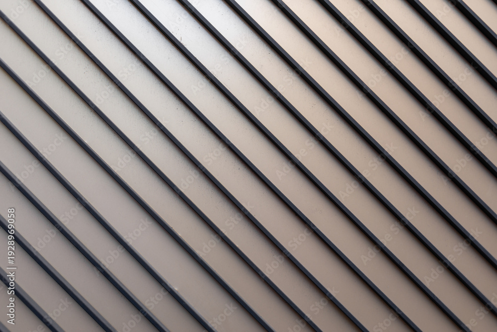 Obraz premium Wall panel with diagonal aluminum slats and elegant texture. Industrial material.