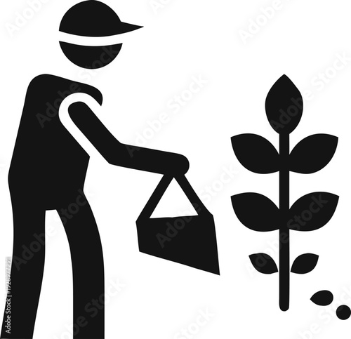 Gardener tending to a plant by applying fertilizer or nutrients for healthy growth