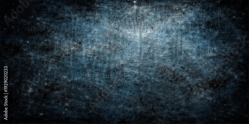 Abstract dark blue background with particles featuring a vintage grunge texture and smoky light patterns on a rough stone wall backdrop