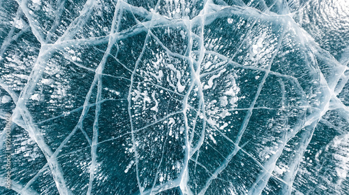 Abstract close-up of frozen lake ice with methane bubbles and cracks
