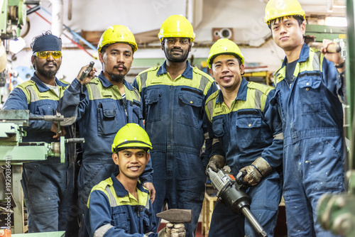 Cuadro en lienzo Ship repair team in engine workshop, heavy industry theme.