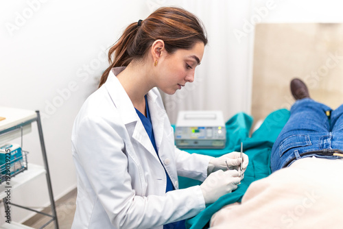 Obraz na płótnie Dermatologist performing minor surgery or biopsy on patient in clinic