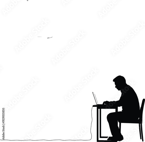Silhouette of a person sitting at a desk working on a laptop