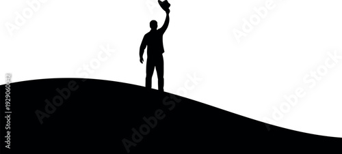Victorious silhouette of a man standing on a hill with raised arm