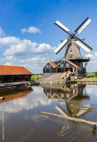 Historic sawmill De Rat with reflection in the water in IJlst, Netherlands