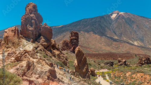 Fotografie Tourists Walking on Roques de Garcia Trail in Teide National Park, Tenerife with