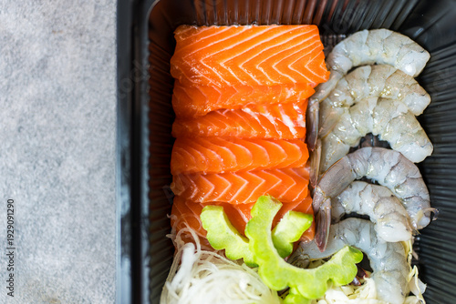 Wallpaper Mural Fresh salmon and raw peeled shrimp neatly arranged in box served with fresh vegetable and bitter melon. Torontodigital.ca