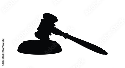 A stark black silhouette depicts a judge s gavel resting on a sound block symbolizing law and order silhouette