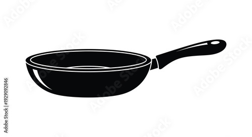 A stark black silhouette of a frying pan stands out against a white background showcasing a simple kitchen essential silhouette
