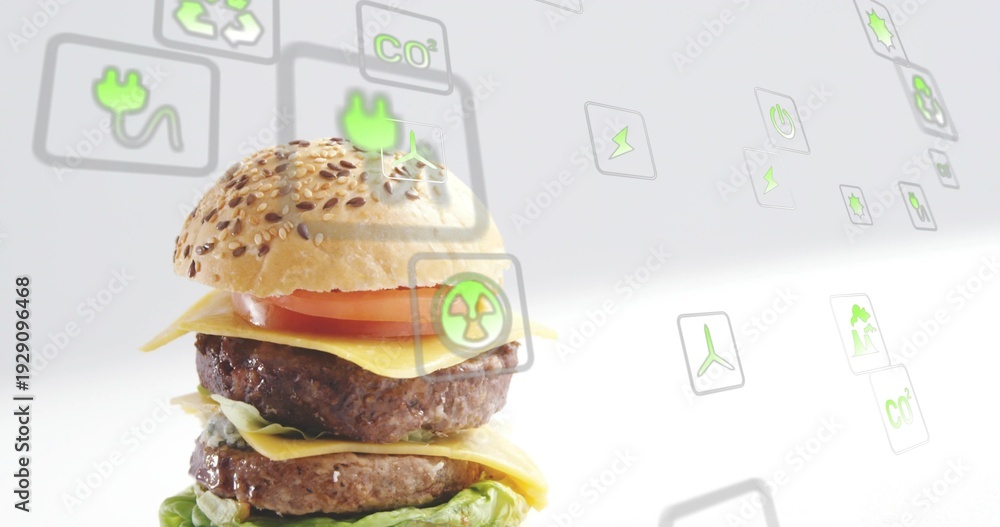 Naklejka premium Displaying double burger with seeded bun, beef patties on studio set with eco icons, copy space