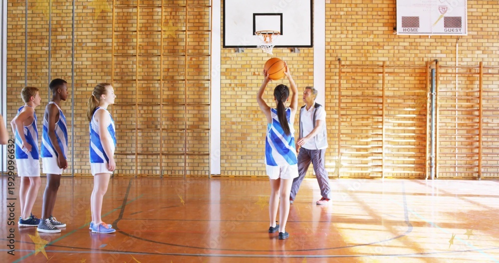 Obraz premium Holding teenage shooter raising basketball under hoop at gym, coach guiding teammates in jerseys