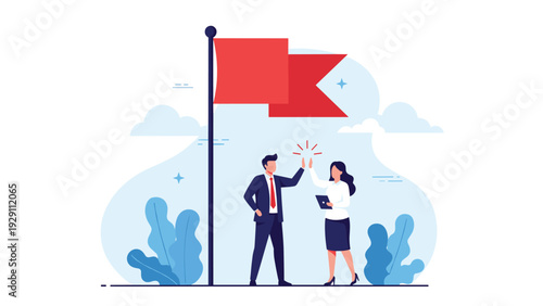 Male and female business partners celebrating their success with a high five next to a red flag on a pole representing a reached milestone.