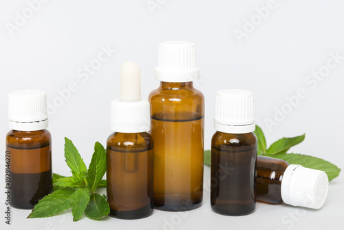 Wallpaper Mural Natural Mint Essential Oil in a Glass Bottle. organic cosmetics with herbal extracts of mint on colored background Torontodigital.ca