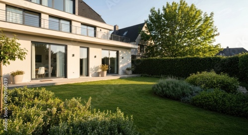 Wallpaper Mural Exterior view of a modern home with manicured lawn, shrubs, trees, and a green hedge Torontodigital.ca