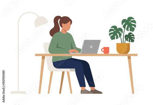 Young woman working on laptop at desk in minimalist home office