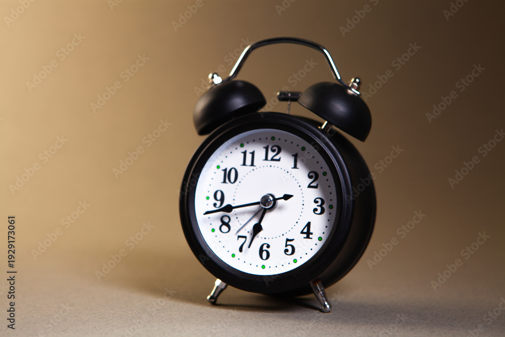 Naklejka premium alarm clock on a black background