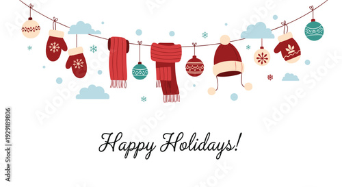 Collection of winter clothes and ornaments hang from a string in a snowy sky with clouds for a happy holiday card.