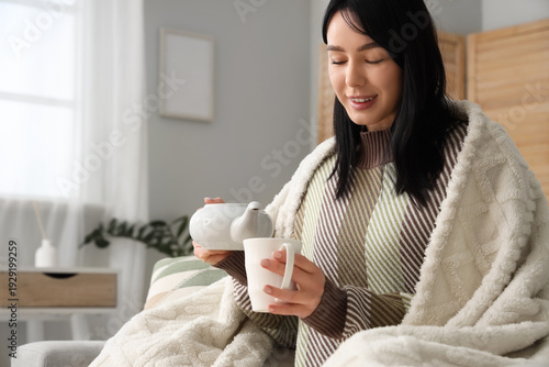 Young woman with warm plaid...